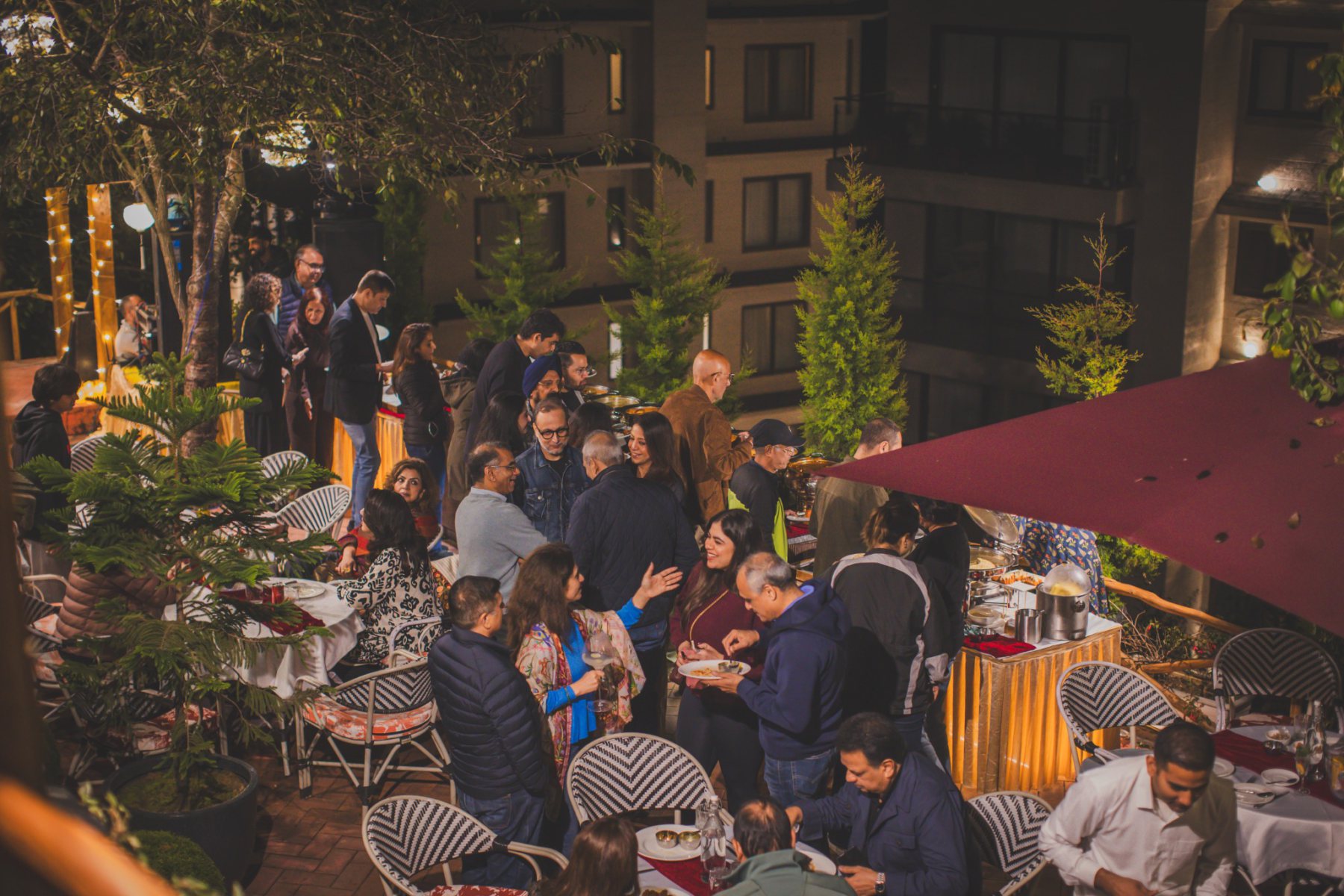 Guests enjoying buffet dining and conversations during the opening evening of Auramah Festival 2026 at Boca Mario, Naldehra.