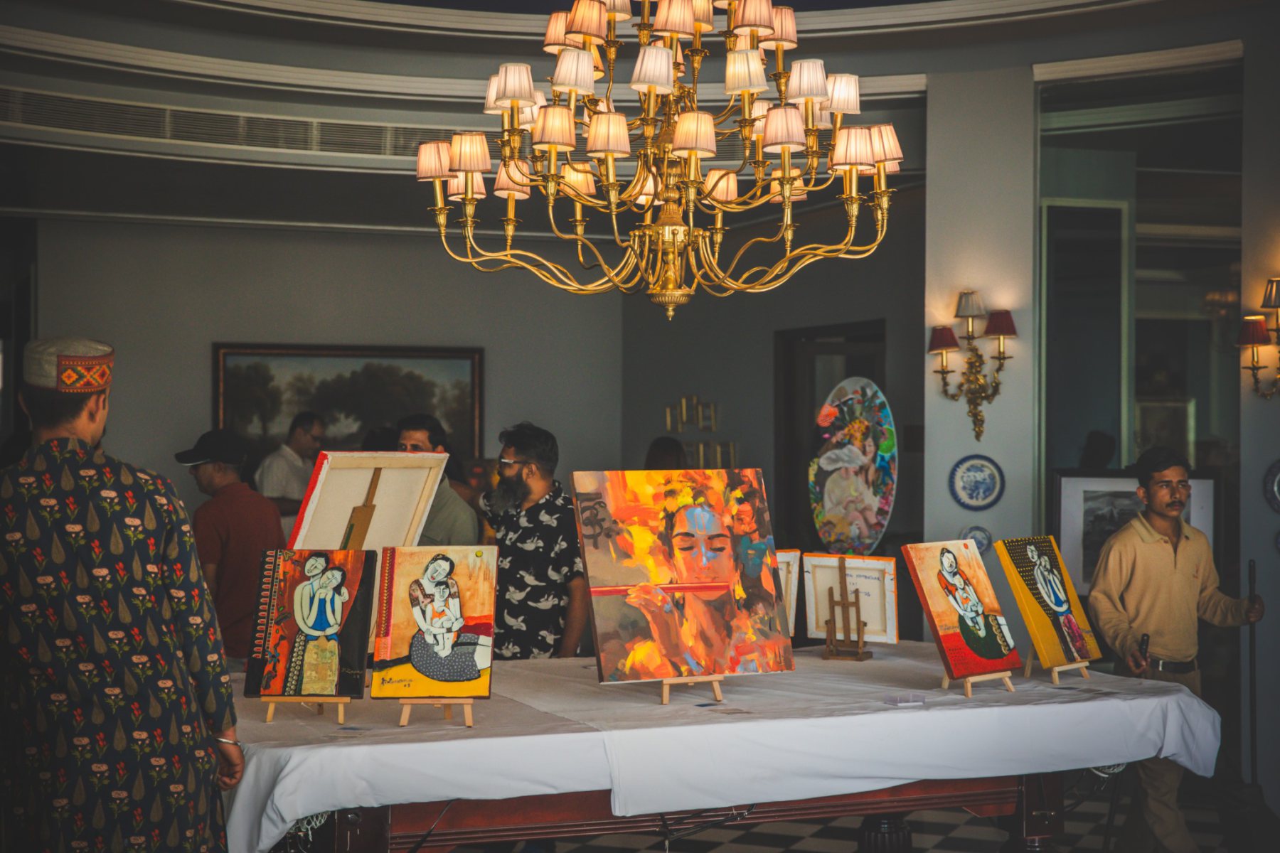 Paintings displayed inside The Manor Clubhouse during Auramah Festival 2026 in Naldehra